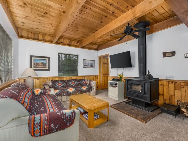 Ponderosa Creekside living room with a wood stove