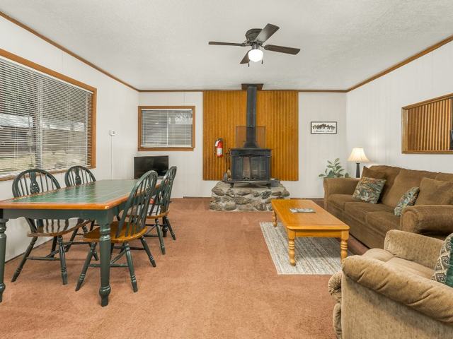 Smokey Bear cabin with a wood stove and dining table