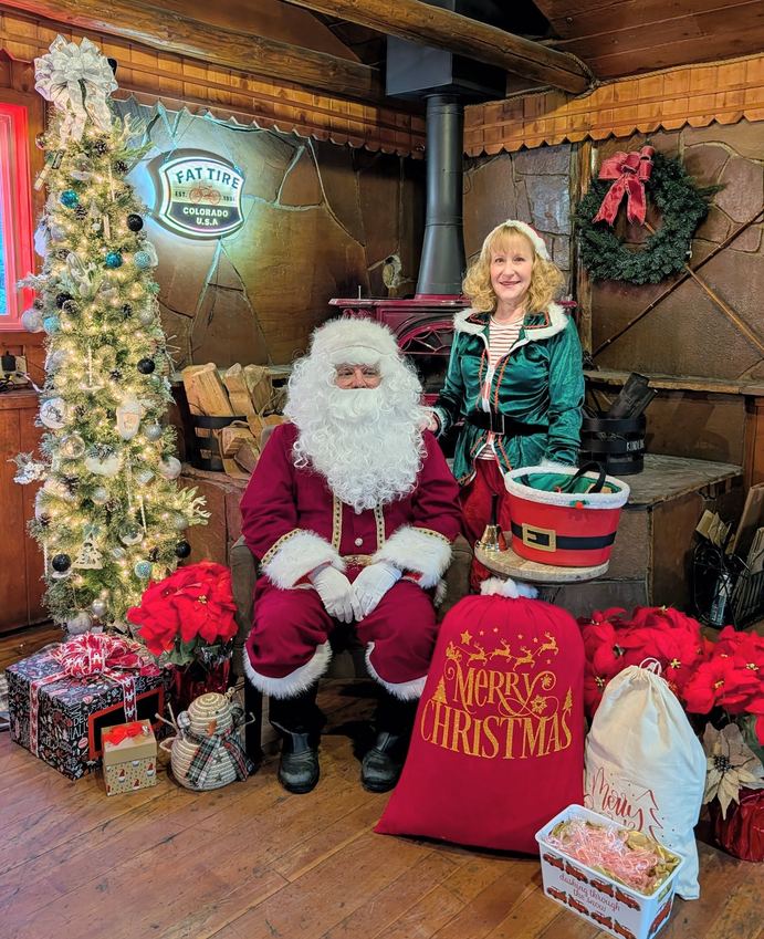 Santa and an elf at a Pondering Pines holiday maker's market